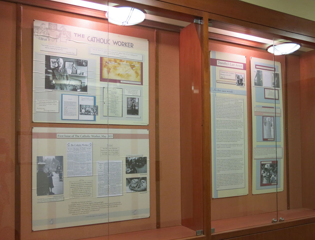 glass-covered display cases of Catholic Worker literature exhibit at Marquette Archive