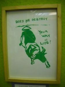 poster with a painted image of farmer and bull with text, "Does he destroy your way of life?"