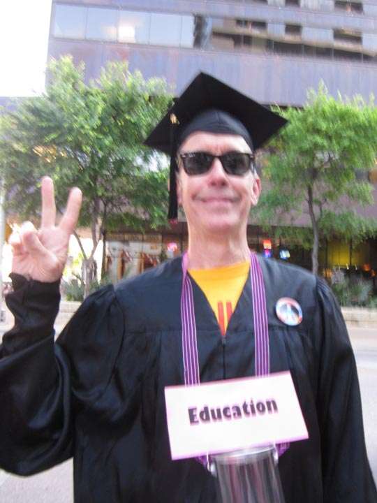 Man dressed in graduation robes, labeled “Education”