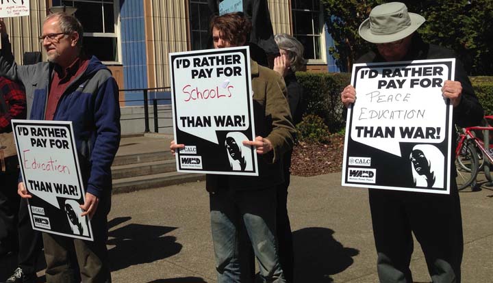 Signs on tax day in Eugene, Oregon