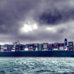 image of a container ship loaded up at sea