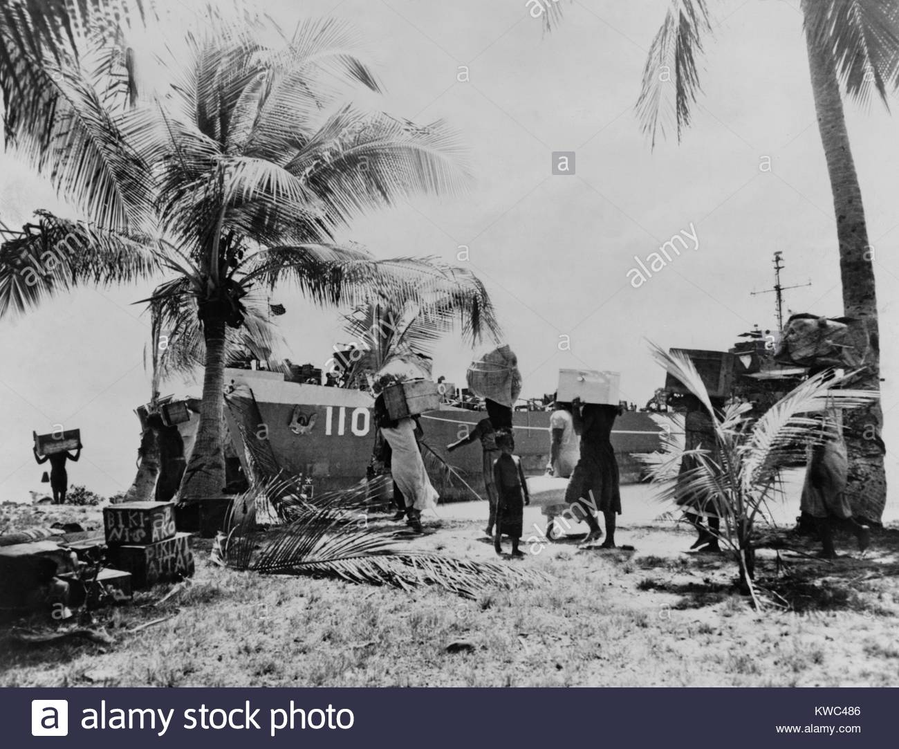People of Bikini Atoll carry their possessions to ships as part of forced relocation