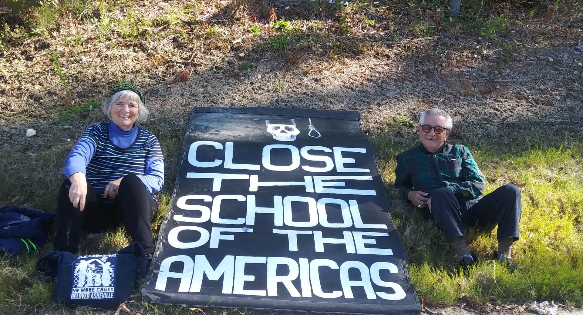 Close the School of the Americas banner with woman and man on both sides