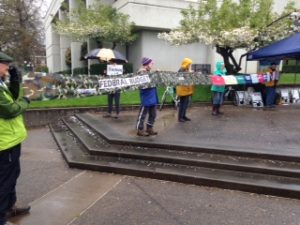 several people holding a banner with different sections representing different areas of US tax funding