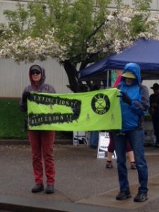 2 people holding a bright green sign 