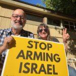 Paul and Kima holding a sign that states, "Stop Arming Israel."