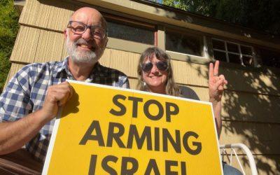 Paul and Kima holding a sign that states, "Stop Arming Israel."