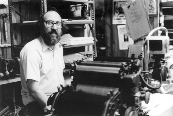 Jerry Chernow sitting at a printing press