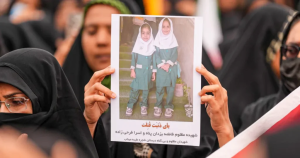 mother holding up girls photo