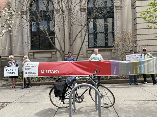 protesters with long banner showing federal budget