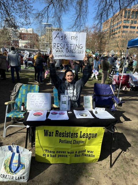 Woman tabling WTR materials at outside event.